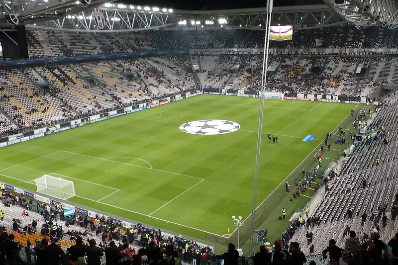 A floodlit stadium before a Champions League night, with the starball on the centre circle